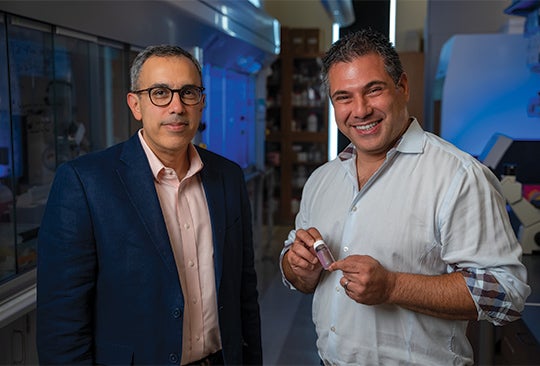 Omid Veiseh (right) and Amir Jazaeri in Veiseh’s Rice laboratory