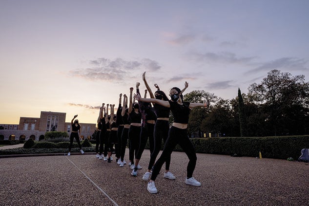 Students exercising in academic quad at sunset