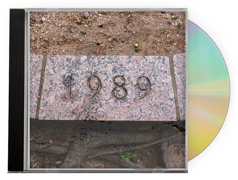 Album cover shows a paving stone etched with the year "1989."