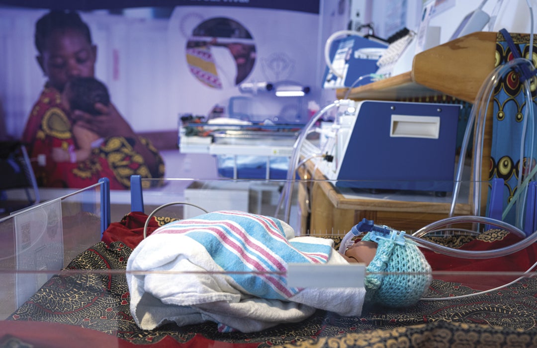 Photo of a prototype of the Pumani bubbleCPAP demonstrated on a baby doll