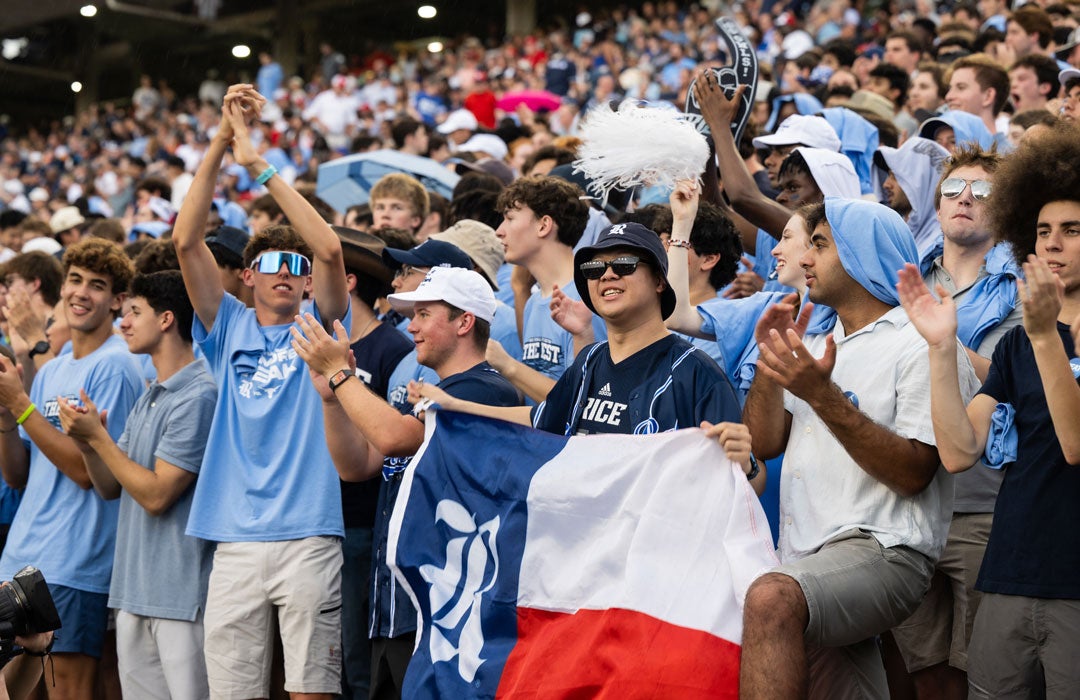 Photo of Hong Lin Tsai holding Rice flag in during a football game
