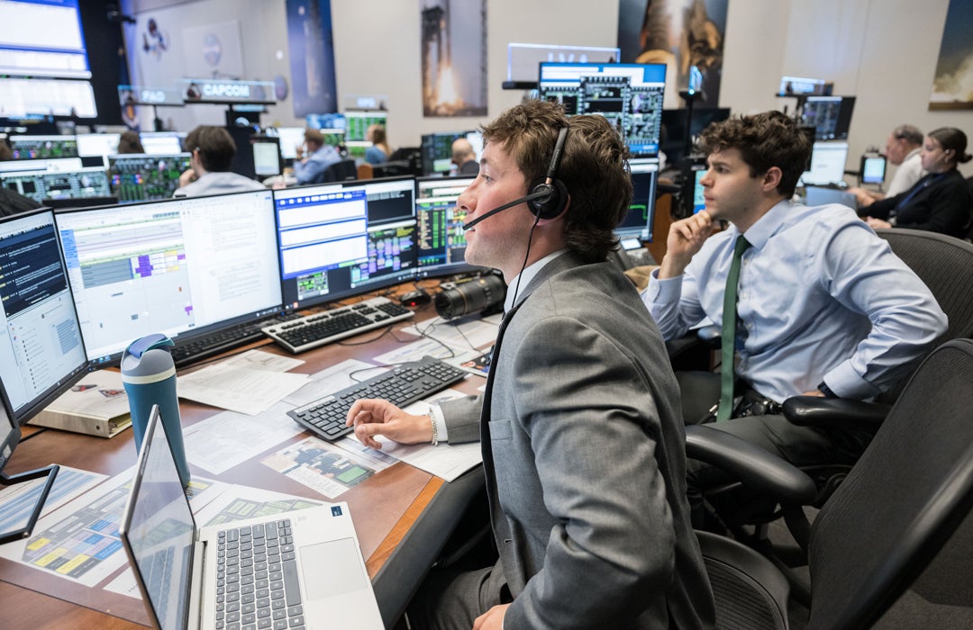Photo of Wyeth McKinley and Will Coben in mission control