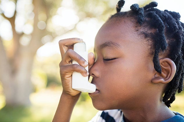 child using asthma inhaler