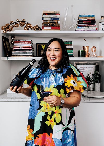 Belinda Chang holds a glass of wine