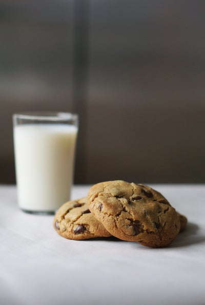 Photo of chocolate chip cookies and a glass of cold milk