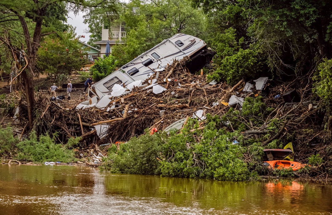 Photo of upturned RV on the banks of the Guadalupe river after flooding