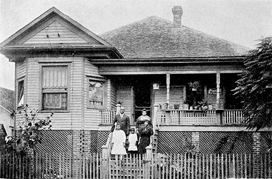 Annie Hagen and her family on the front porch of their home at 609 Hobson St. in 1915