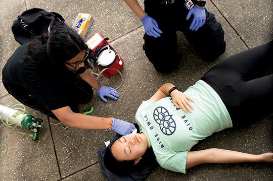Students in EMSP 281 practice their patient assessment skills during live scenario training. 
