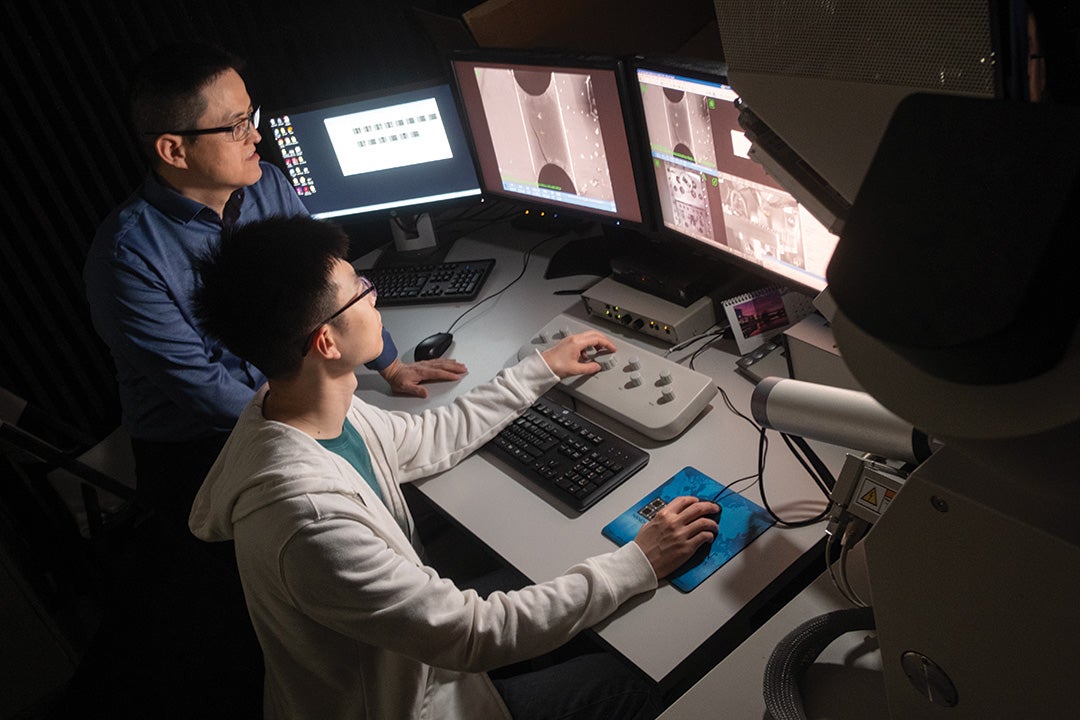 A photograph of Rice materials science and nanoengineering professor Jun Lou in the lab with a graduate student