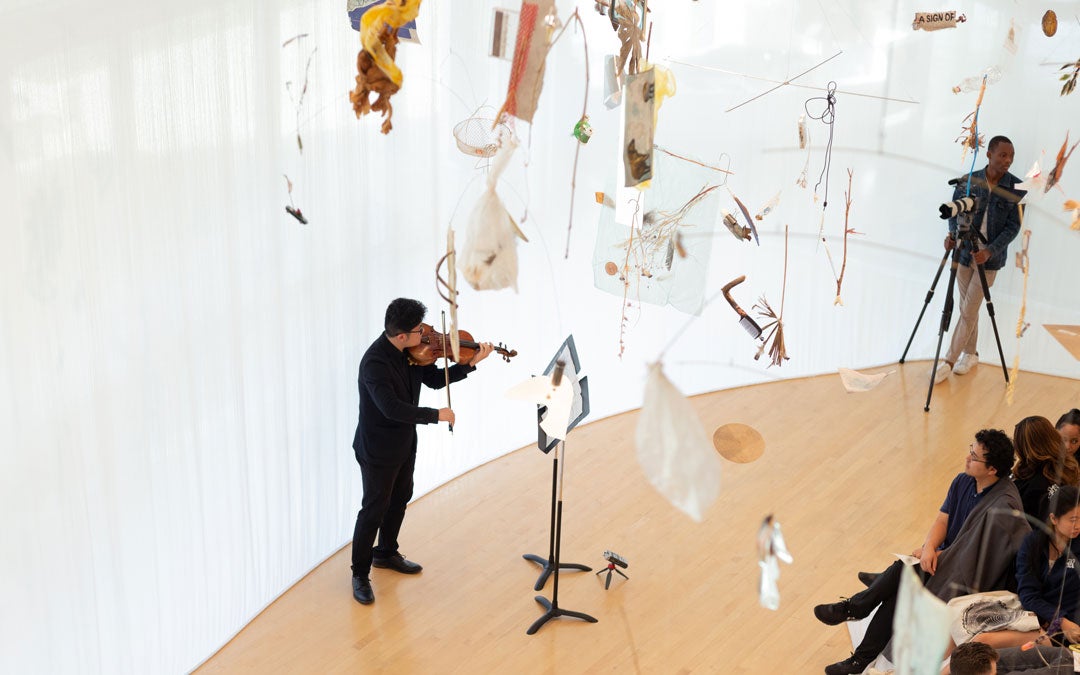 Photo of violinist performing during an opening exhibit at Moody Center For The Arts