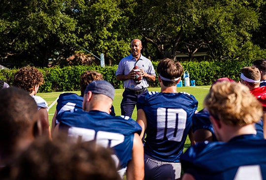 Athletics: President DesRoches met with the Rice football team during in August.