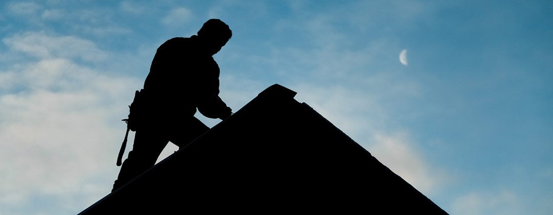 Photo of a person repairing a roof