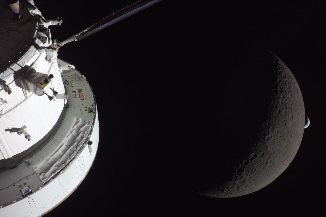 Photo in space from the Orion capsule: the right side of NASA’s Orion spacecraft is seen lit up by the Sun. A waxing crescent Moon is visible behind it. And then, a crescent Earth, tiny compared to the Moon, is about to set below the Moon’s horizon on the right. 