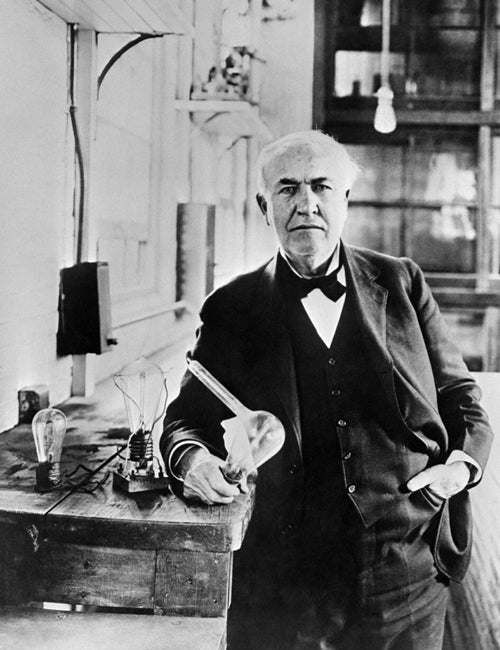 Photo of Edison holding a lightbulb