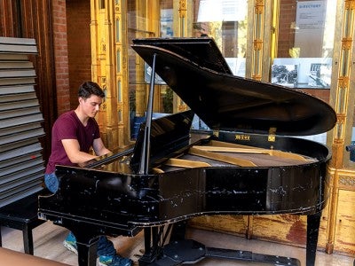 A student plays The Baldwin Grand Piano
