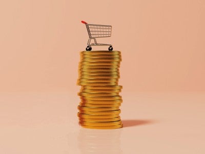 Grocery cart on stack of gold coins