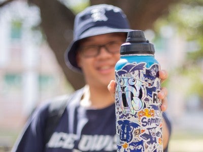 Students share water bottle sticker decorations