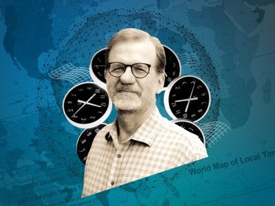 Photo of Paul Eggert with clocks and time zone world map in the background
