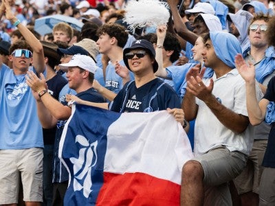 Photo of Hong Lin Tsai holding Rice flag in during a football game