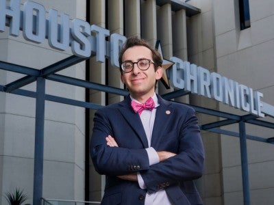 Photo of Evan Mintz in front of the Houston Chronicle building