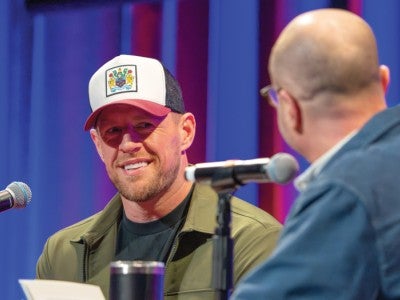 Photo of JJ Watt during an live audience podcast interview