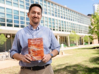 Photo of Scott Solomon holding his newly released book