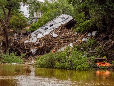 Photo of upturned RV on the banks of the Guadalupe river after flooding