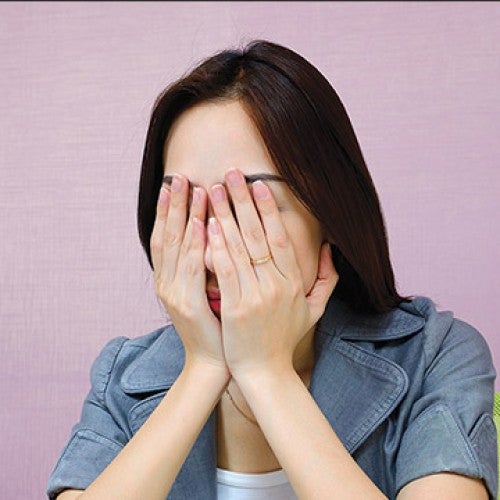 Female with hands covering face